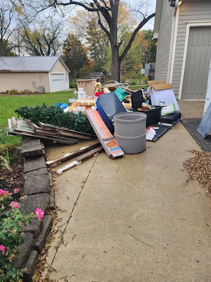 Dumpster being loaded with debris for Estate Cleanout Dumpster Rental in Ruston
